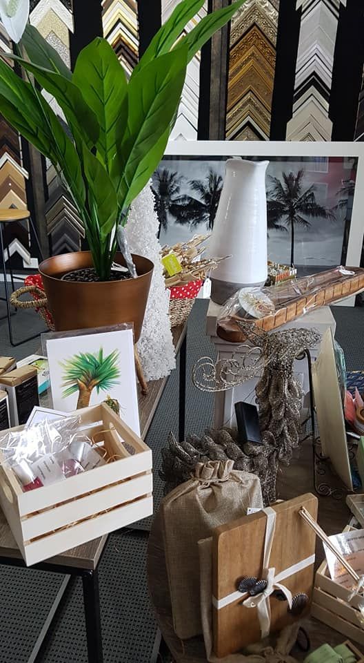A Display Table With Plants, Art, and Gifts in Front of Framing Store — Tropical North Framing Gallery Cairns in Cairns, QLD