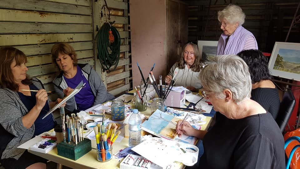 Women Painting Together at a Table in a Workshop — Tropical North Framing Gallery Cairns in Atherton Tablelands, QLD
