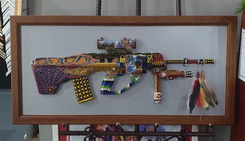 Framed Colourful Decorative Gun, Decorated With Beads and Feathers — Tropical North Framing Gallery Cairns in Cairns, QLD