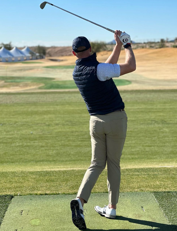 Andrew Knoll warming up on the driving range before playing golf