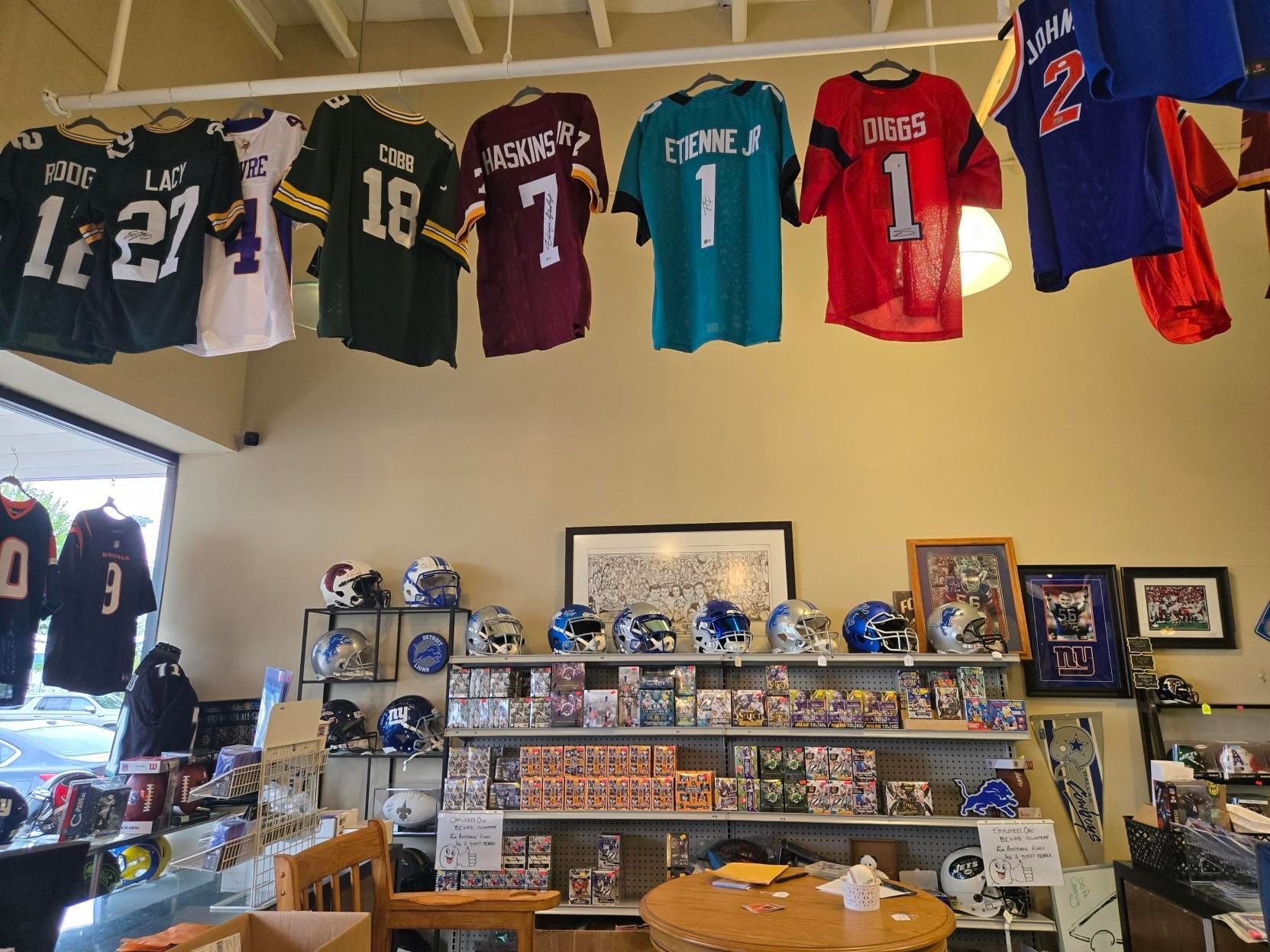 A shelf in a store filled with boxes and packs of magic the gathering cards.