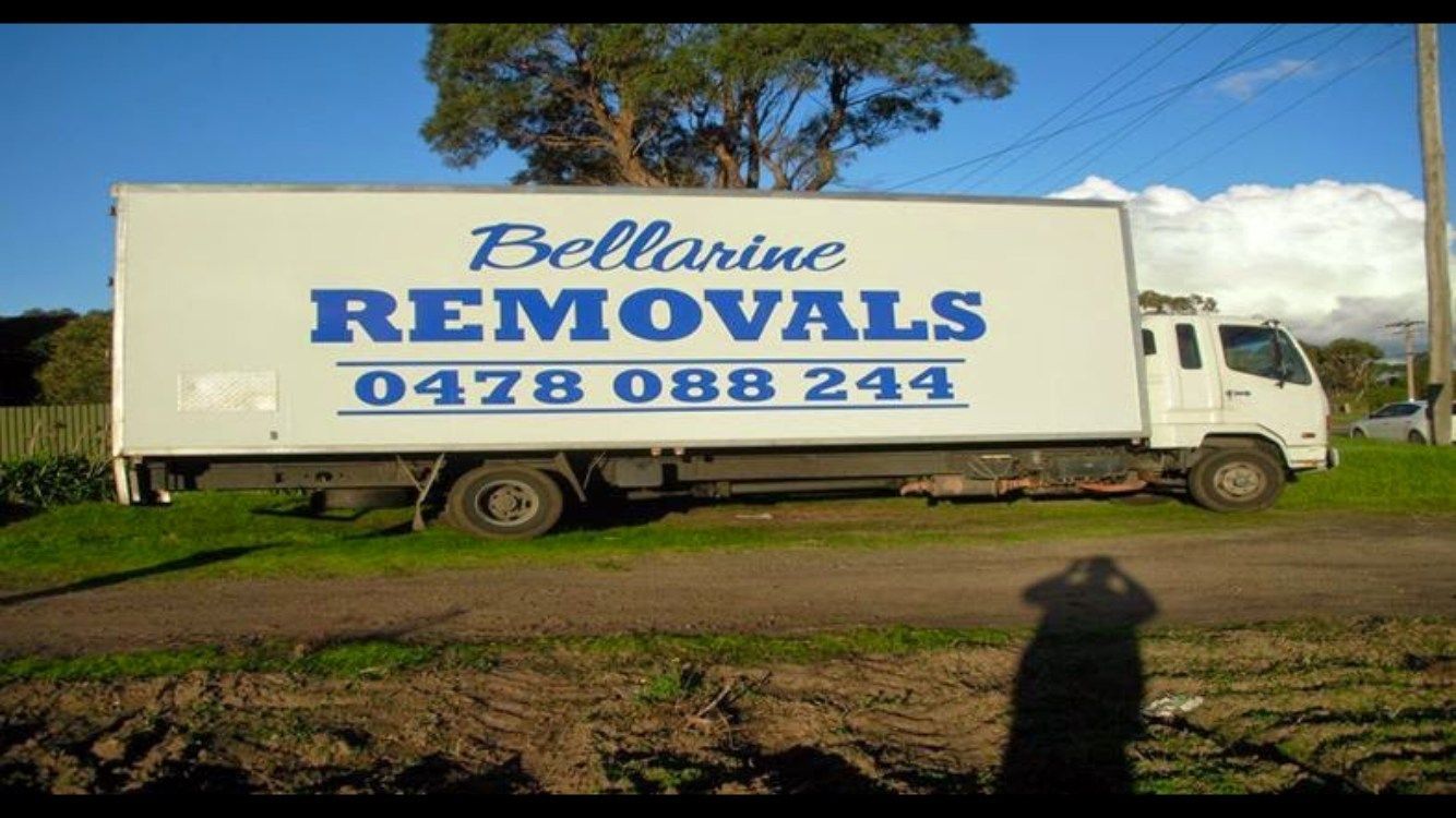 A White Moving Truck is Parked in In a Field — Bellarine Removals In Surf Coast, VIC