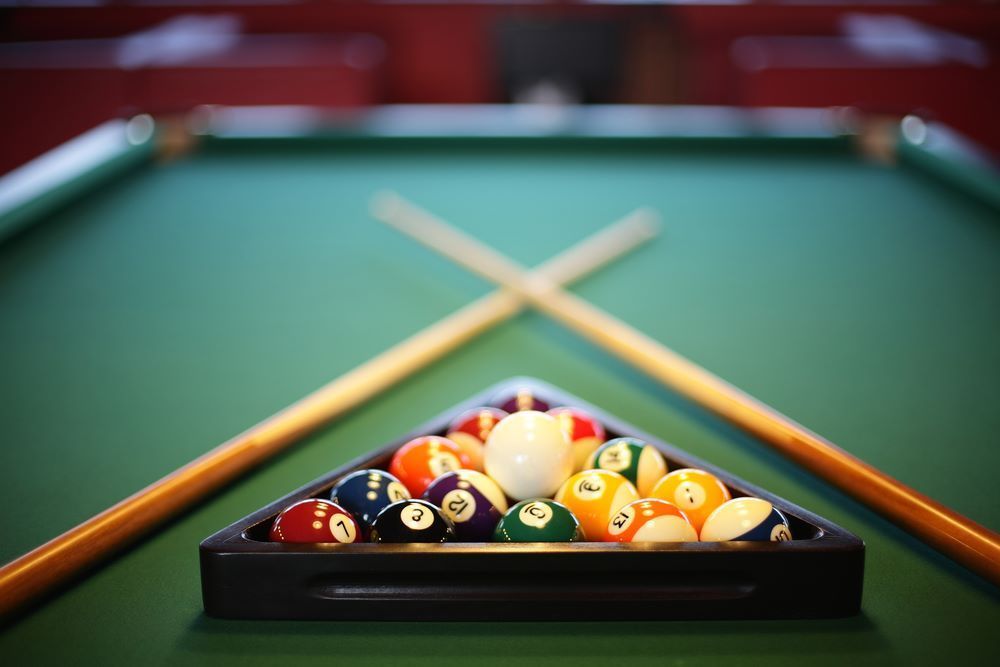 A Pool Table With Pool Balls and Cues on It — Bellarine Removals In Armstrong Creek, VIC