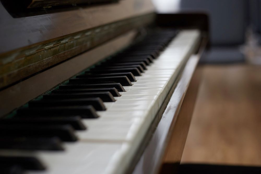 A Close Up of a Piano Keyboard on a Wooden Floor — Bellarine Removals In Armstrong Creek, VIC