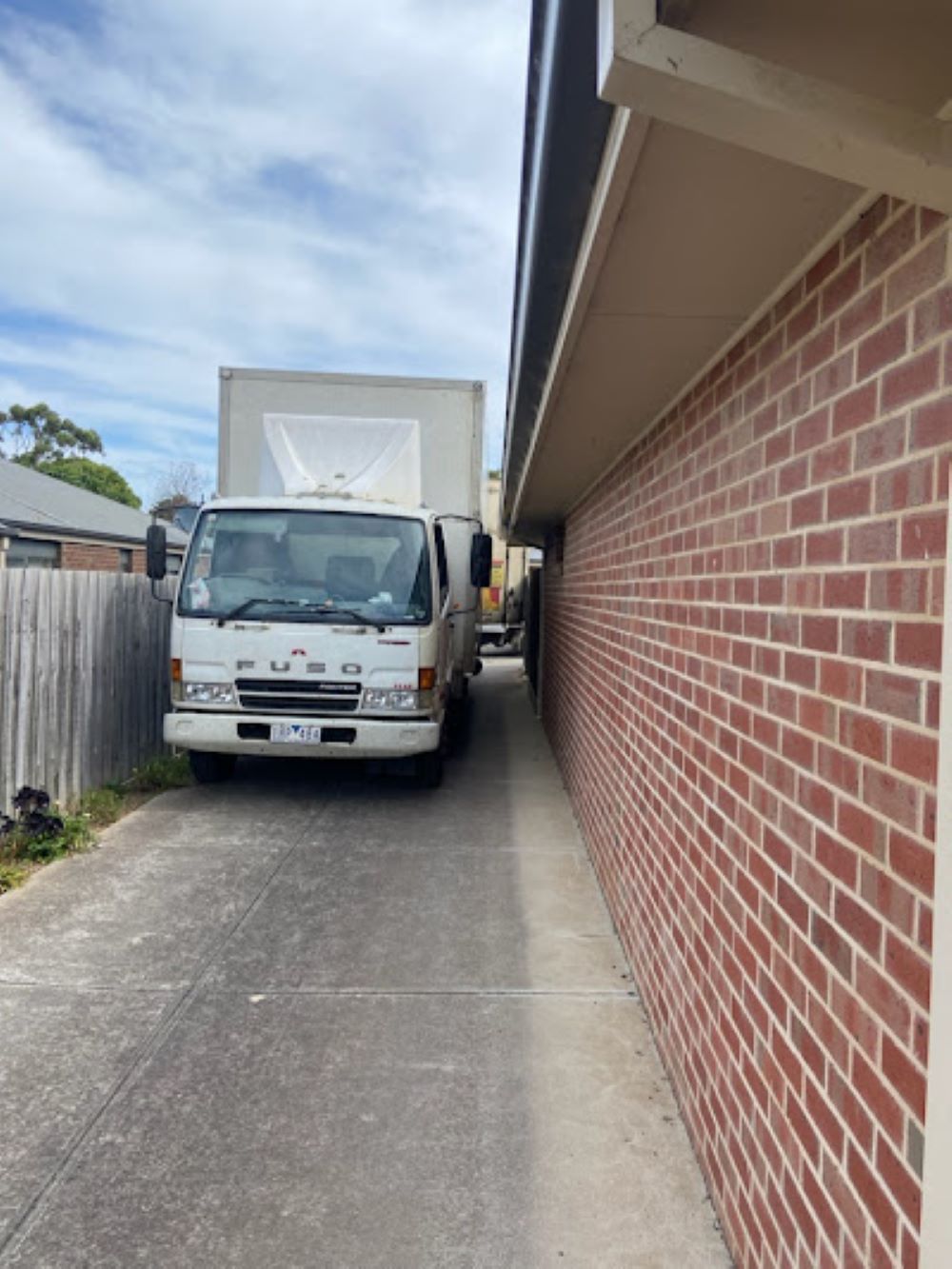 A White Truck is Parked Next to a Brick Wall — Bellarine Removals In Ballarat, VIC