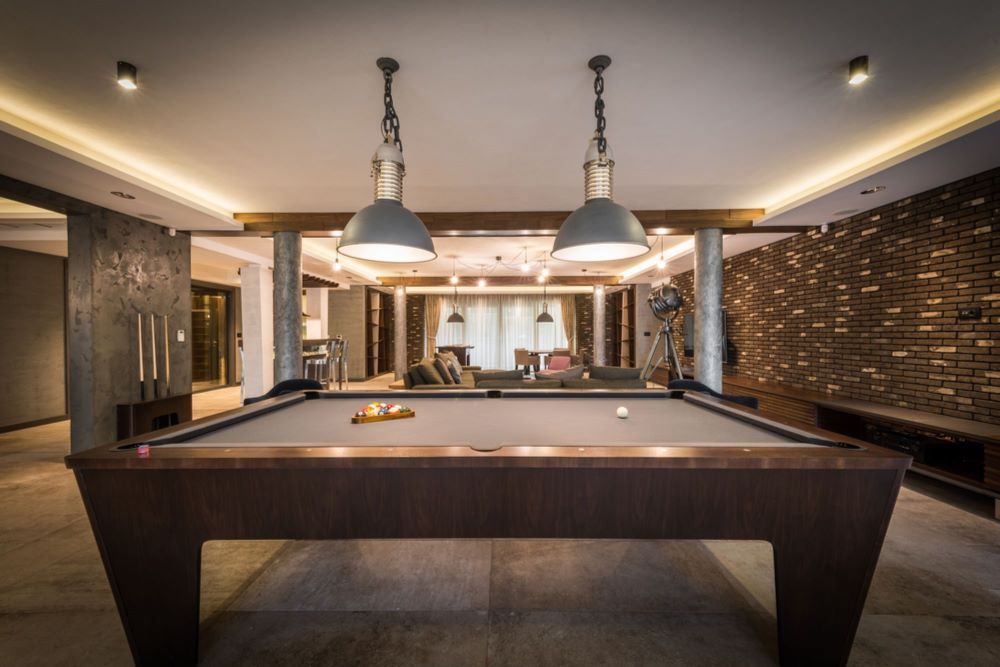 A Pool Table in a Living Room With Two Lamps Hanging From the Ceiling — Bellarine Removals In Geelong, VIC
