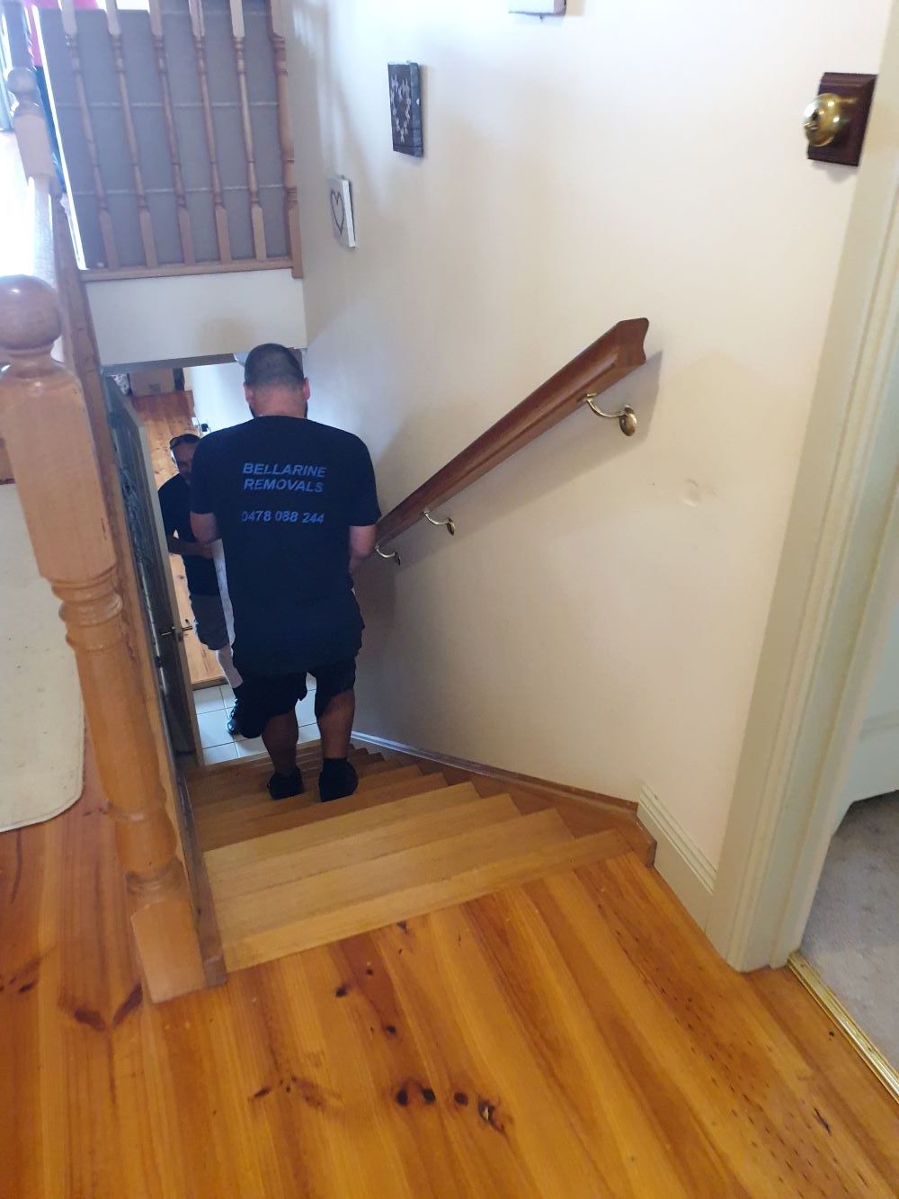 A Man is Walking Up a Set of Stairs in a House — Bellarine Removals In Geelong, VIC