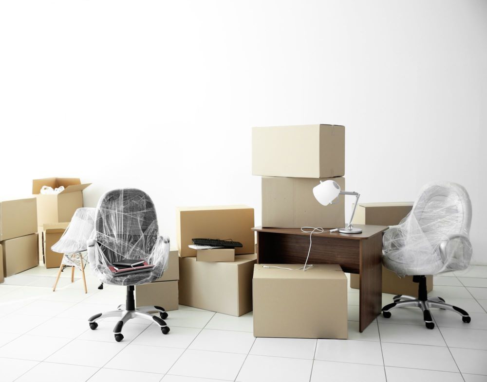 A Room Filled With Boxes, Chairs, a Desk and a Lamp — Bellarine Removals In Melton, VIC