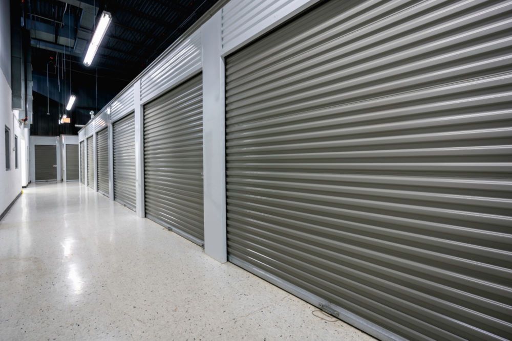 A Long Hallway With a Row of Storage Units — Bellarine Removals In Melton, VIC