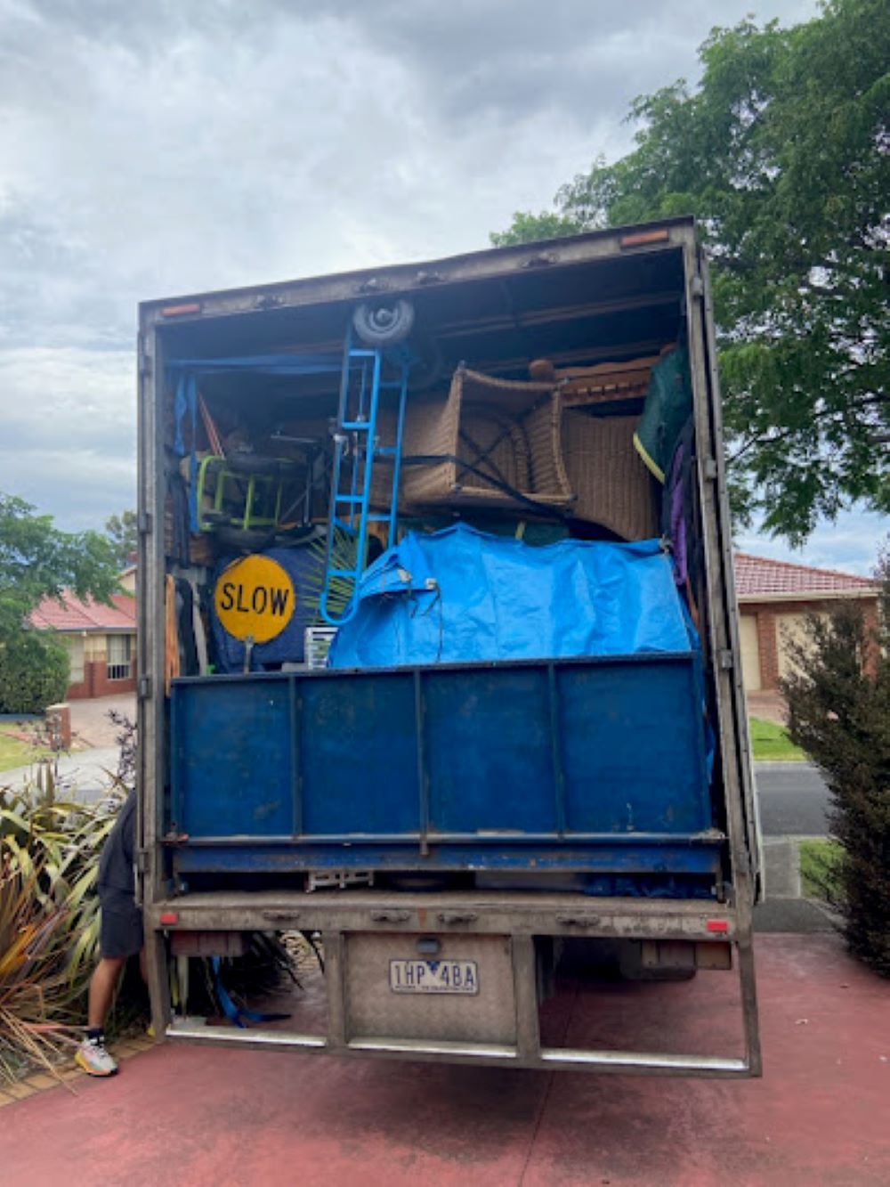 A Moving Truck is Filled With Furniture and a Blue Tarp — Bellarine Removals In Warrnambool, VIC