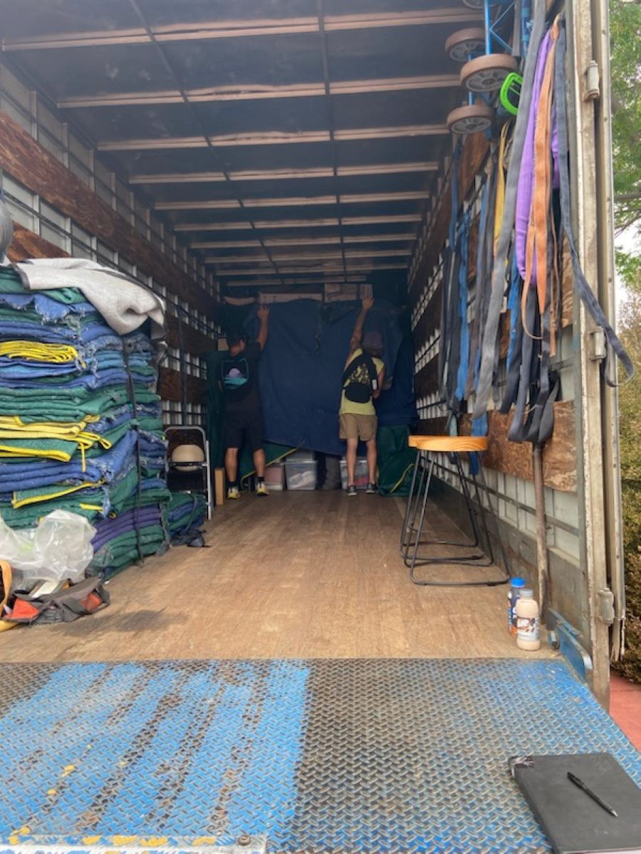 A Man is Standing in the Back of a Truck — Bellarine Removals In Warrnambool, VIC