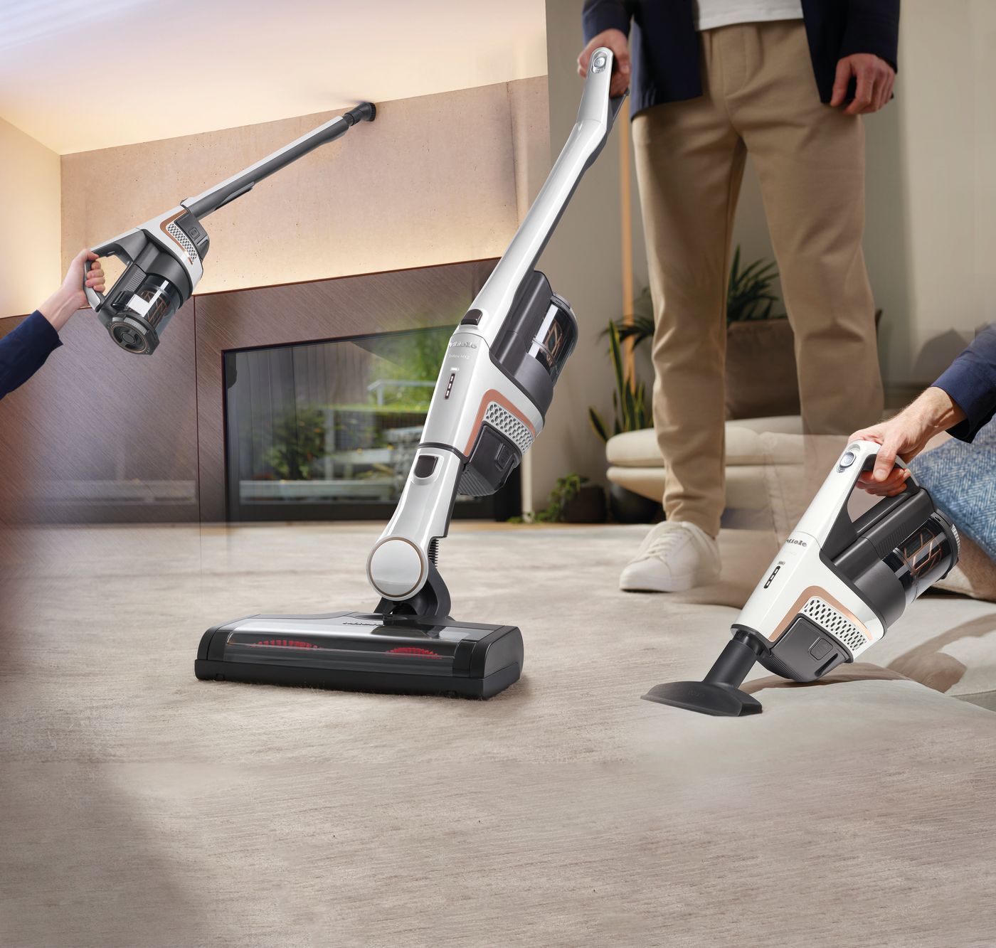 People demonstrating a white and black cordless vacuum cleaner in different positions on a carpet.