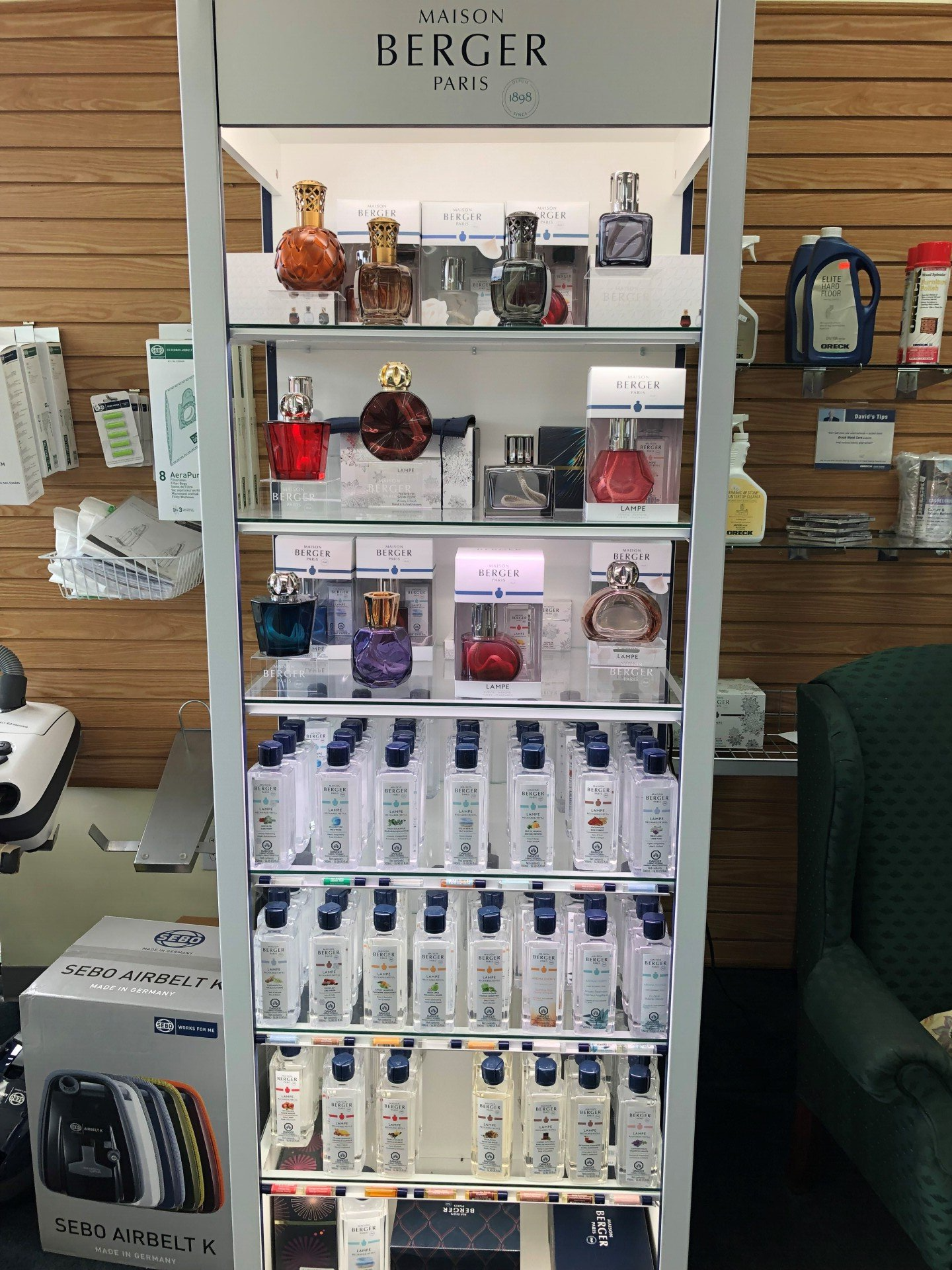 Display shelf with Berger Paris fragrances. Various bottles in glass and silver shelves.