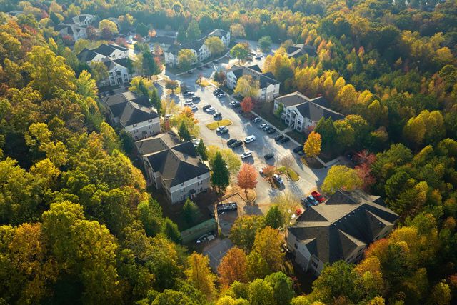 An aerial view of a residential area surrounded by trees and houses.