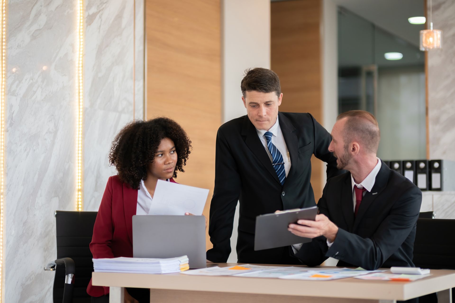 A group of business people are having a meeting in an office.