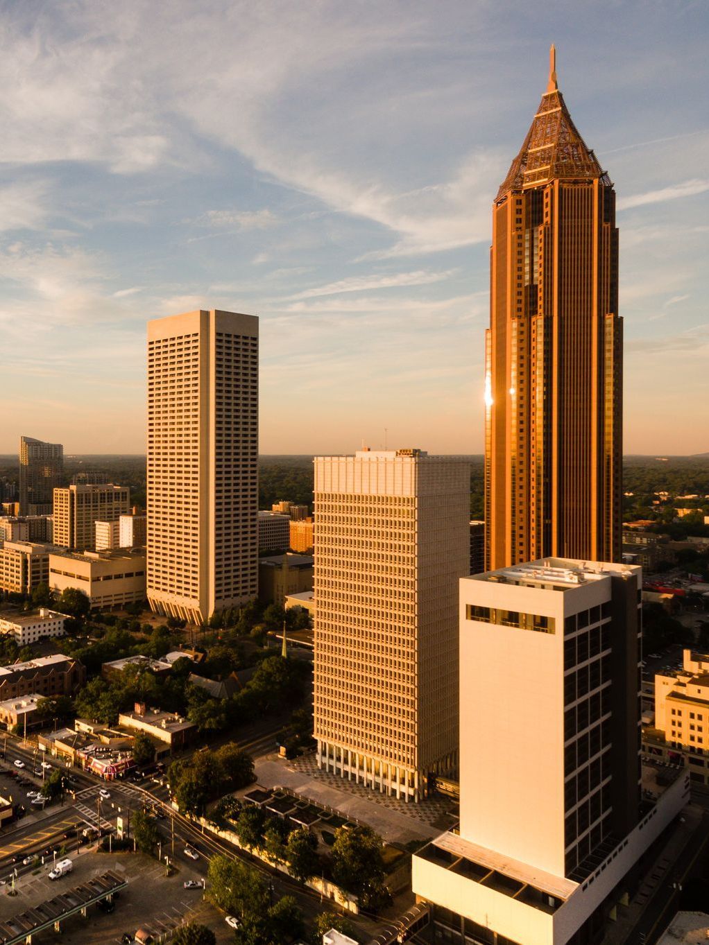 An aerial view of a city with a tall building in the middle