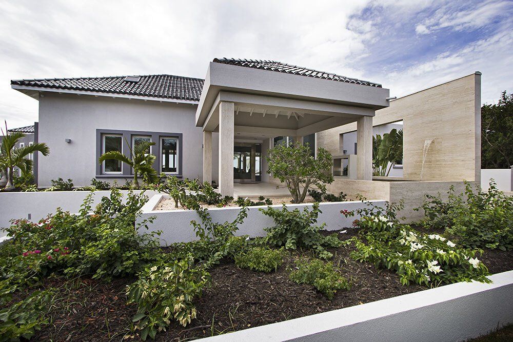A white house with a porch and a lot of windows