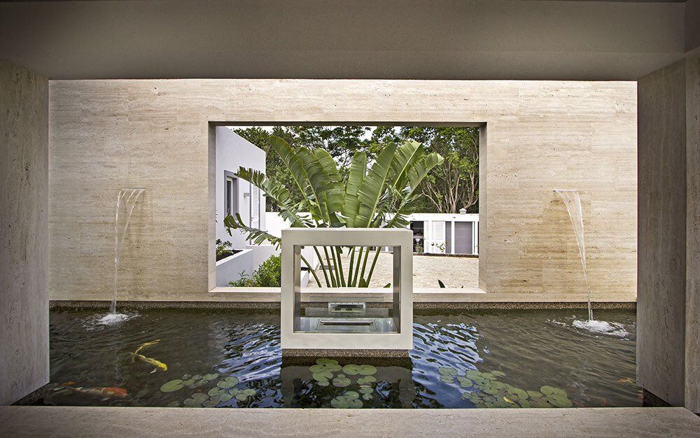 A pond with a fountain in the middle of it