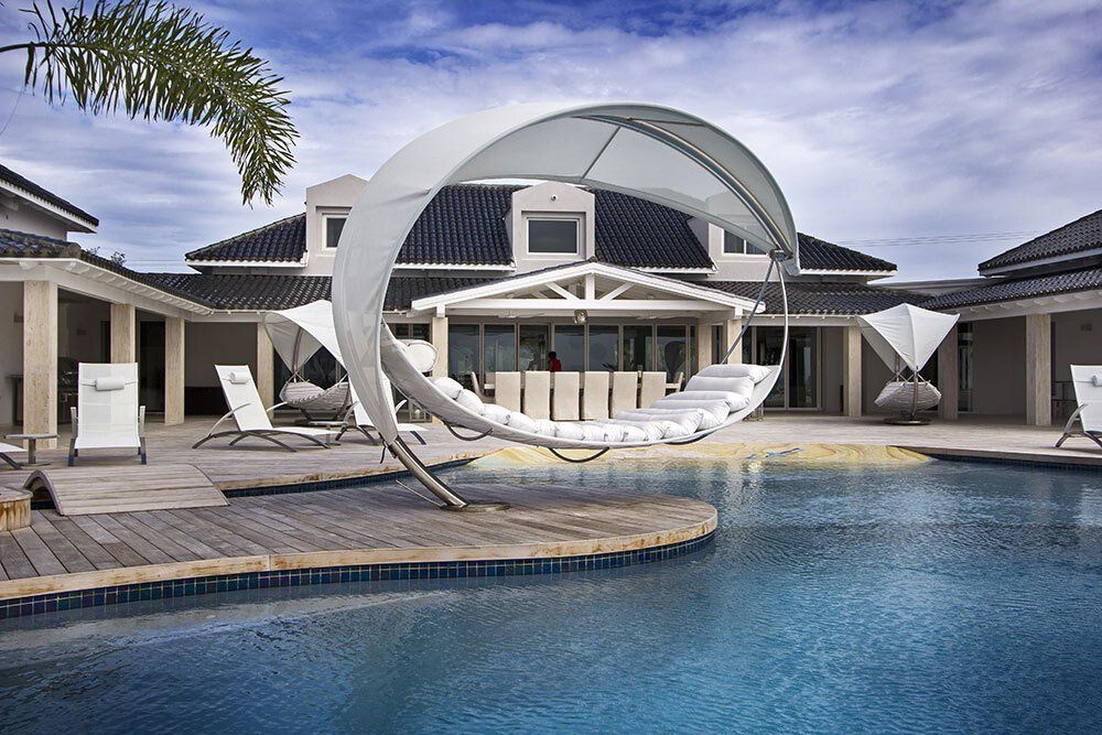 A large house with a swimming pool in front of it