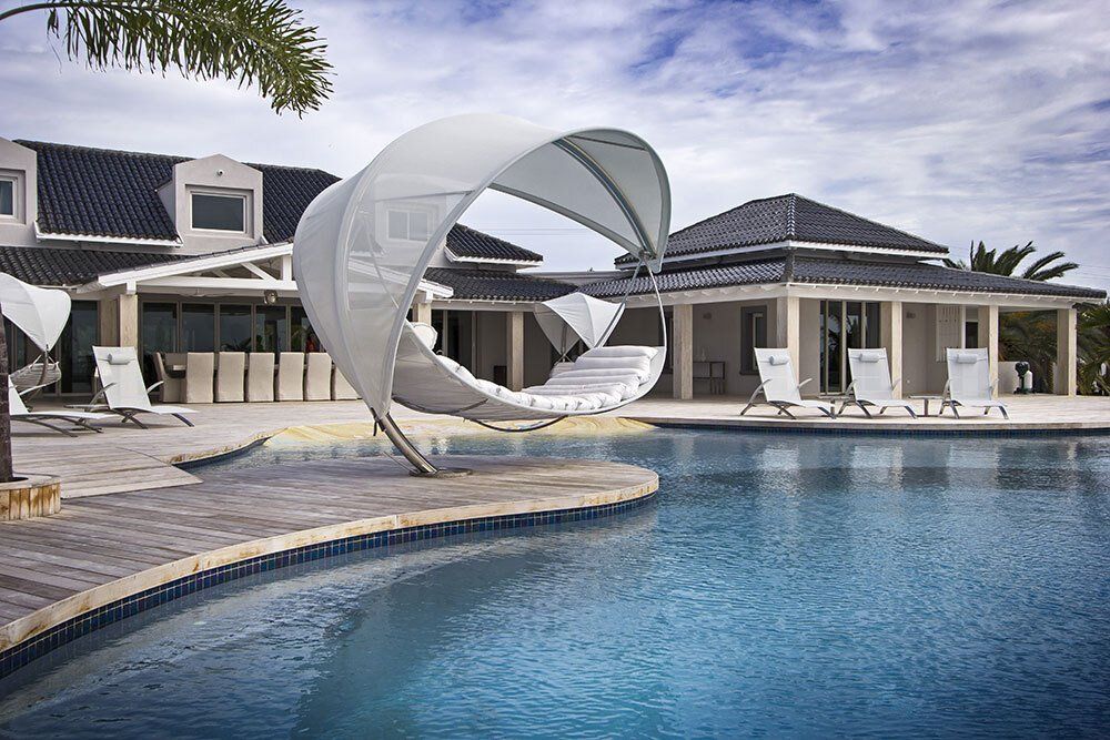 A large house with a swimming pool in front of it
