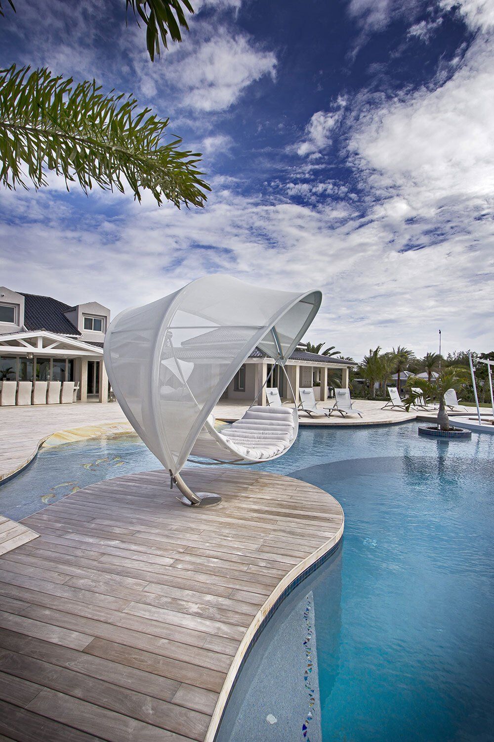 A large swimming pool with a white canopy over it.