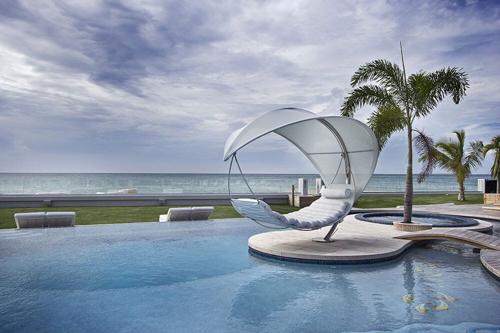 A swimming pool with a hammock in the middle of it