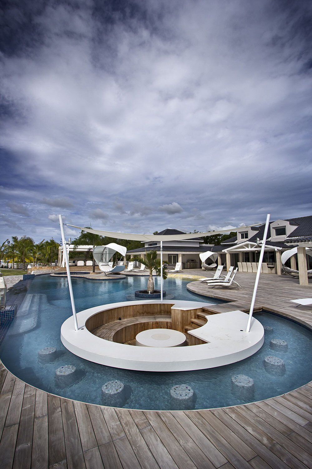 A large swimming pool with a circular area in the middle of it