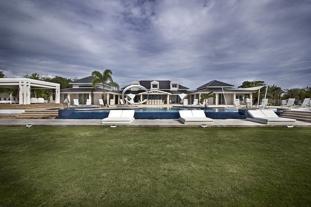 A large house with a swimming pool in front of it