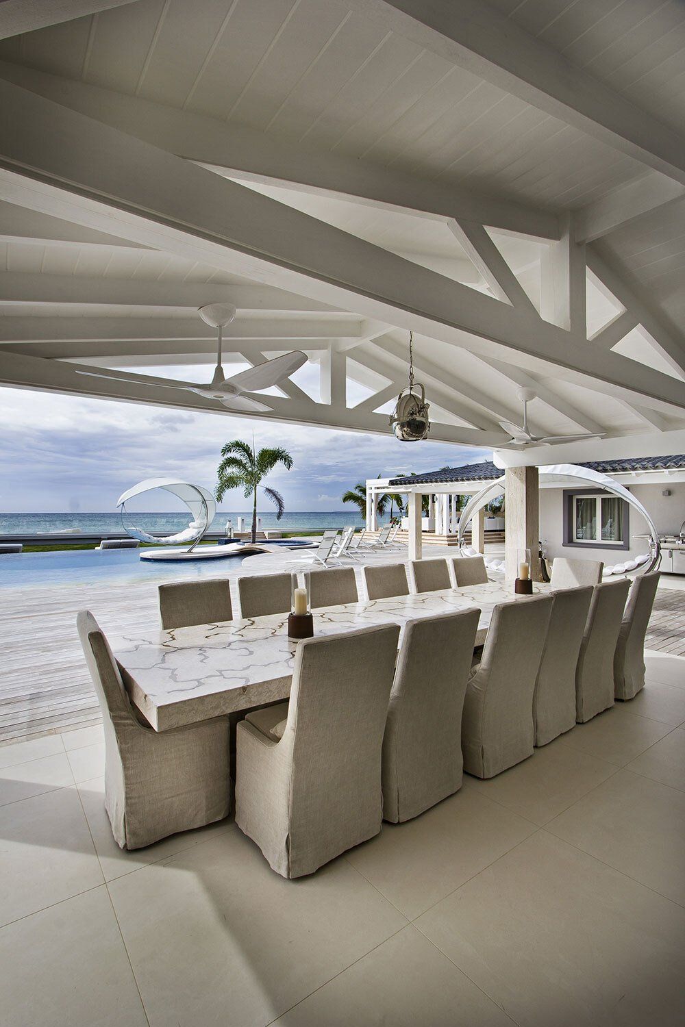 There is a large table and chairs in the middle of the room.