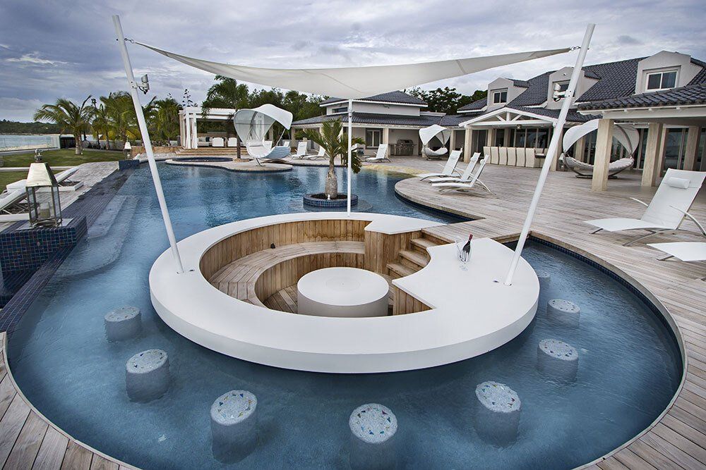 A large swimming pool with a circular table in the middle