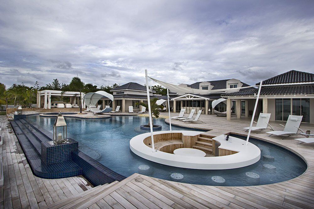 A large swimming pool with a circular island in the middle