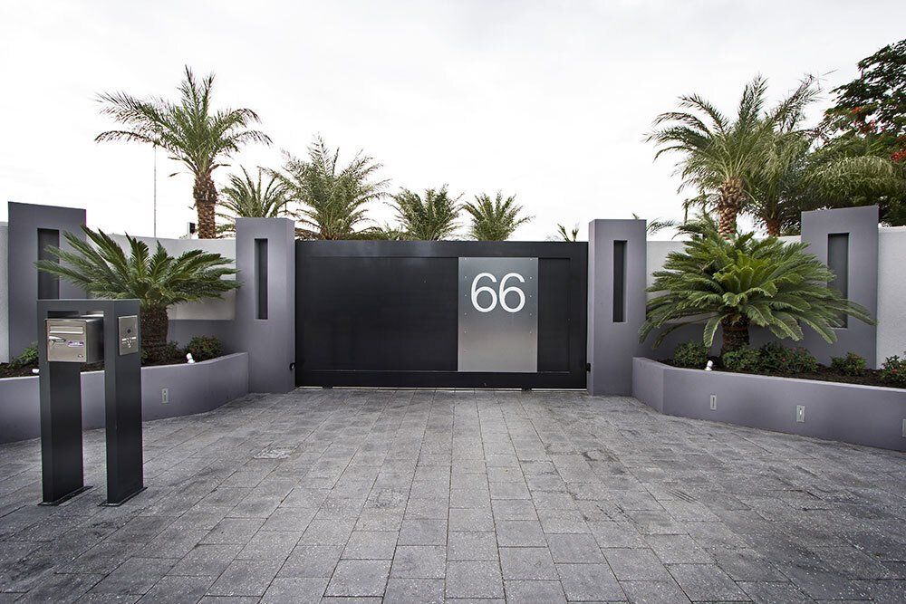A black gate with the number 66 on it