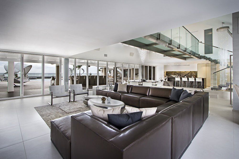 There is a large couch in the middle of the living room.