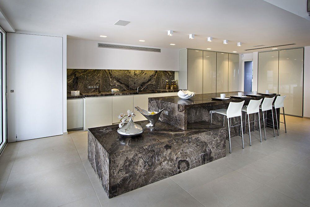 A kitchen with a large island in the middle