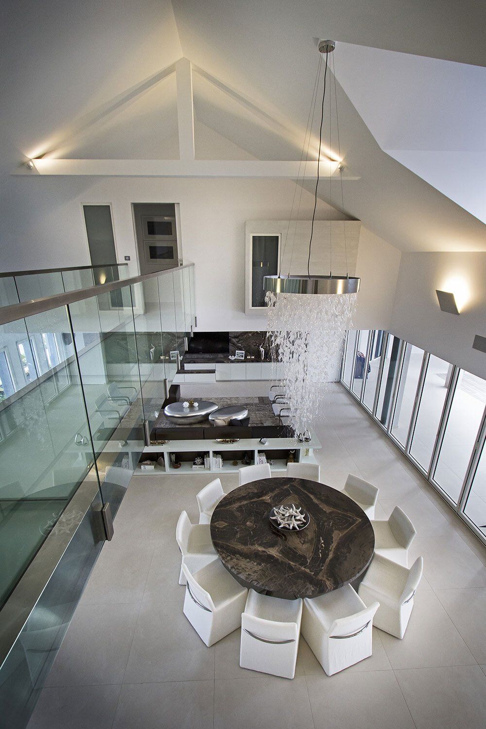 An aerial view of a dining room with a round table and chairs