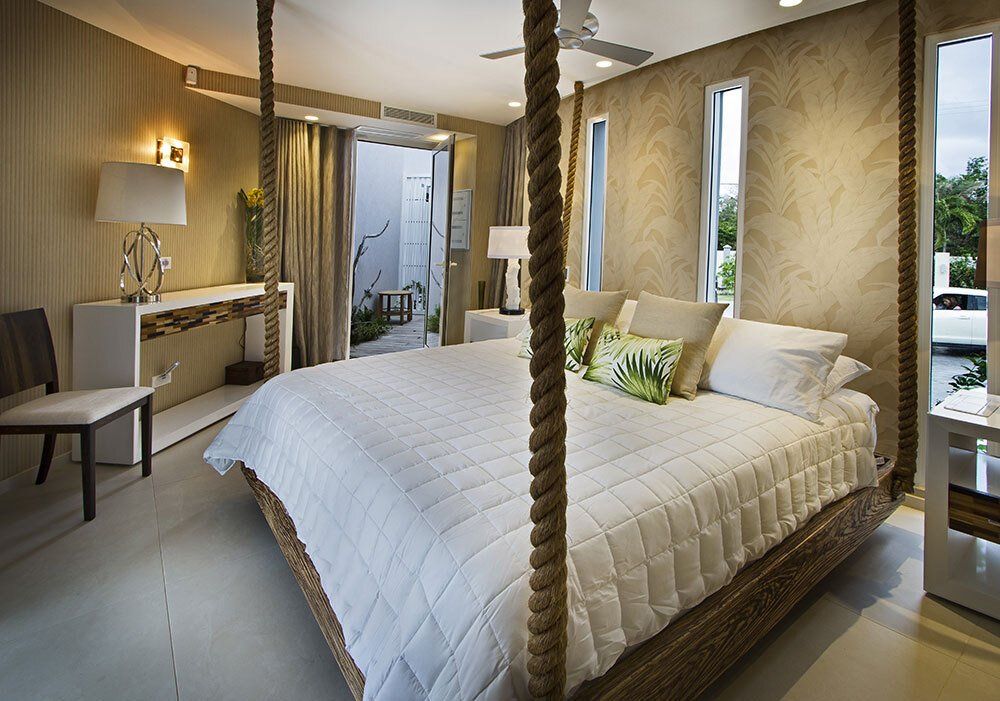 A bedroom with a rope bed and a chair