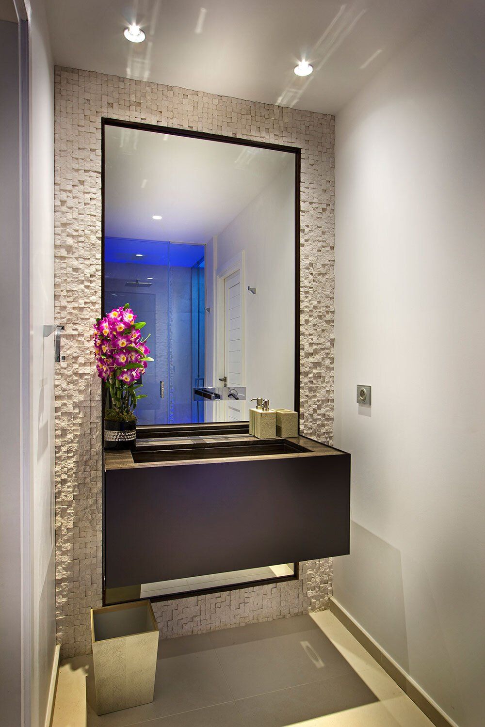 A bathroom with a large mirror and a sink