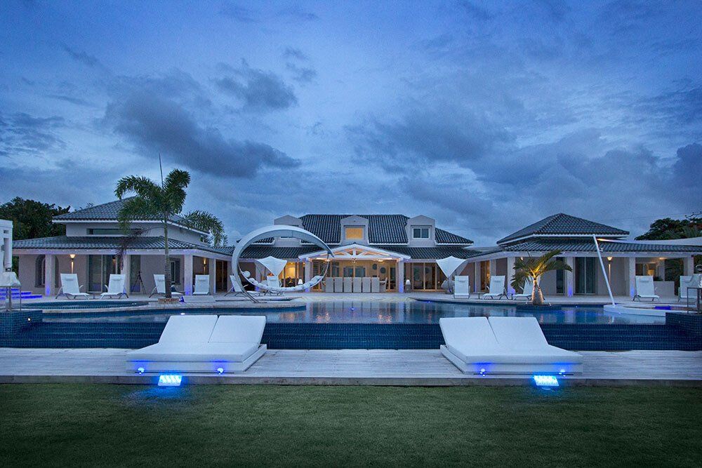 A large house with a swimming pool in front of it