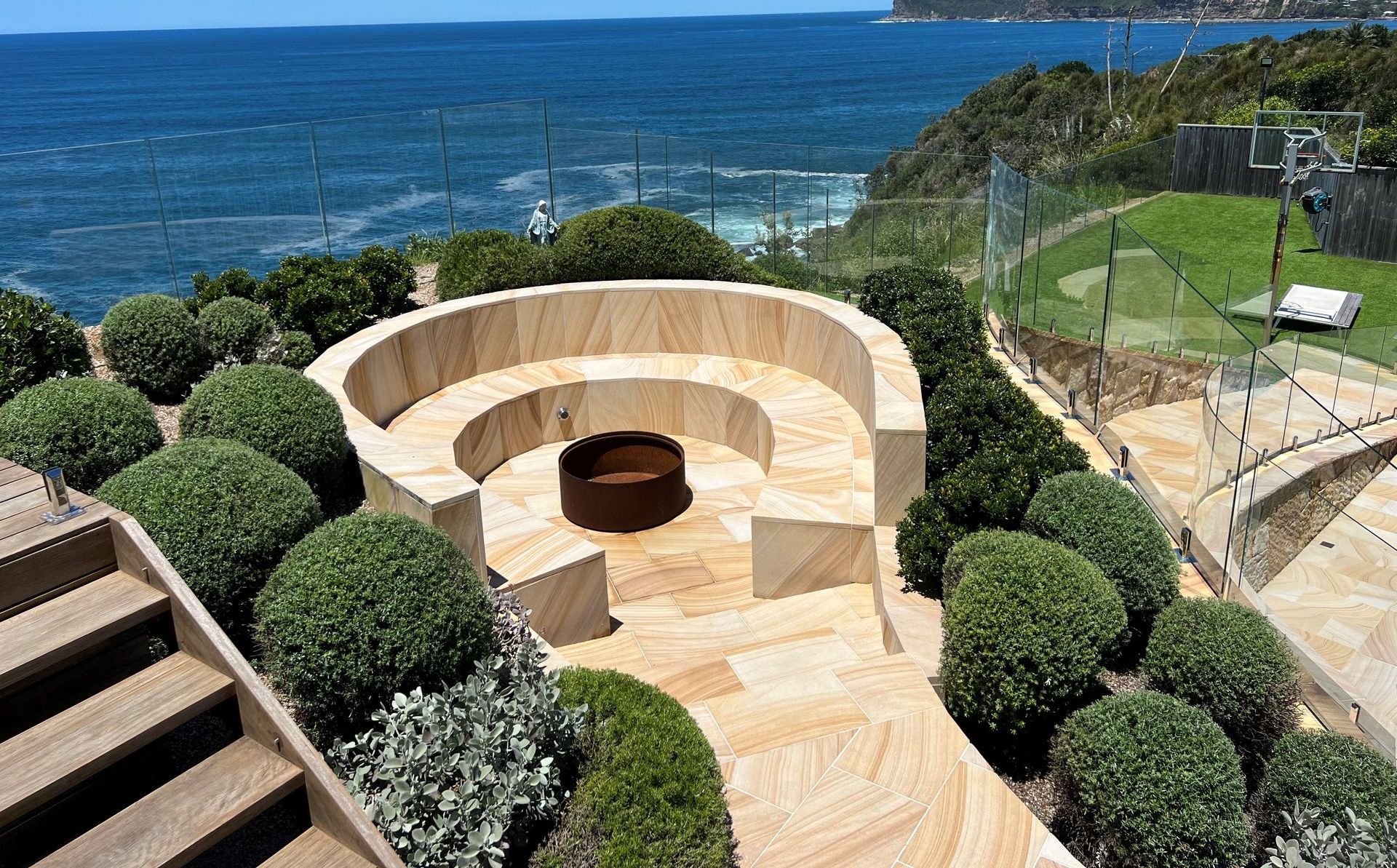 Stone Fire Pit Seating Area Overlooking the Ocean — Divine Landscape Creations in Berkeley Vale, NSW