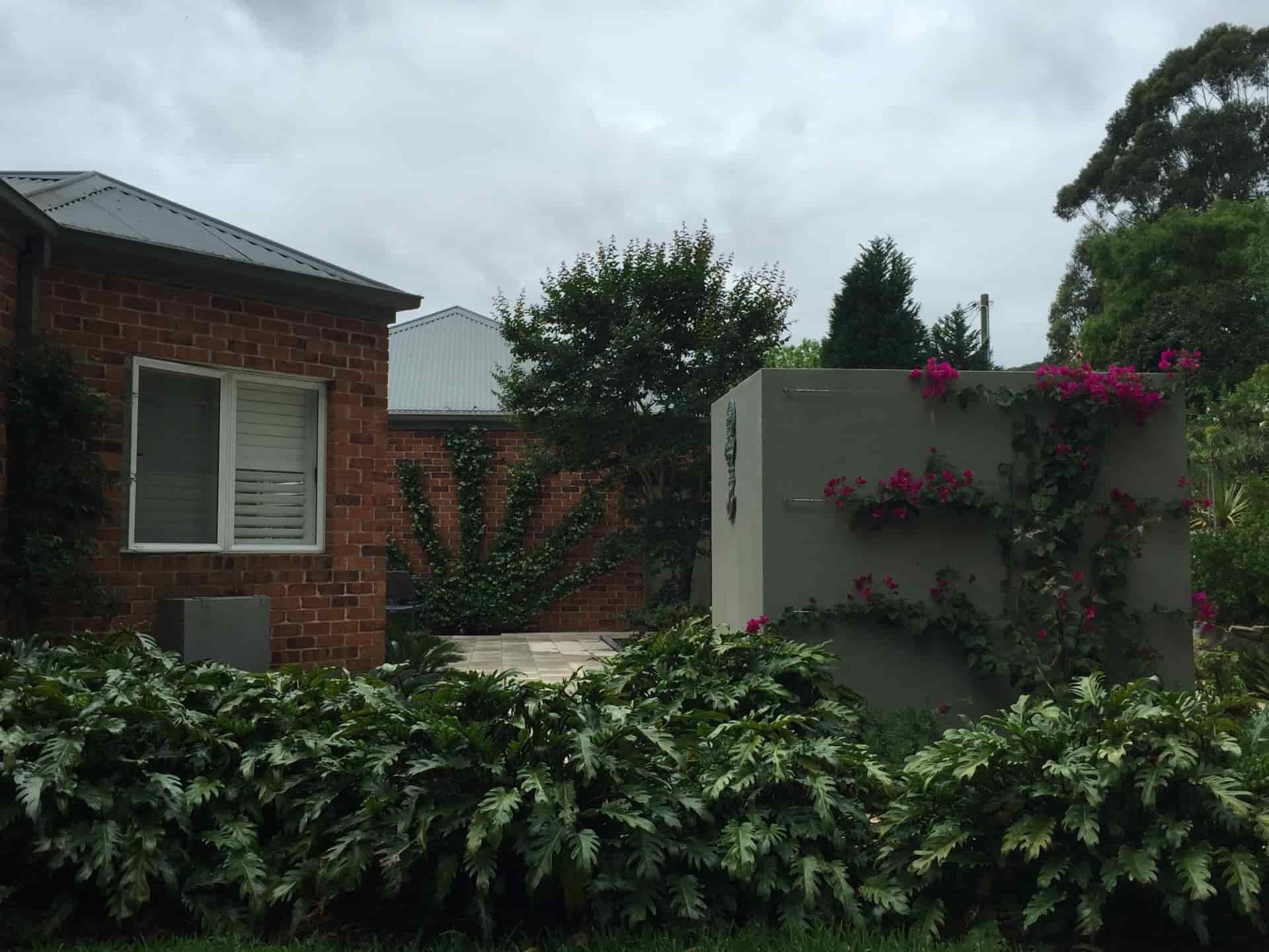 Brick Building With a Window and a Large Concrete Wall — Divine Landscape Creations in Berkeley Vale, NSW