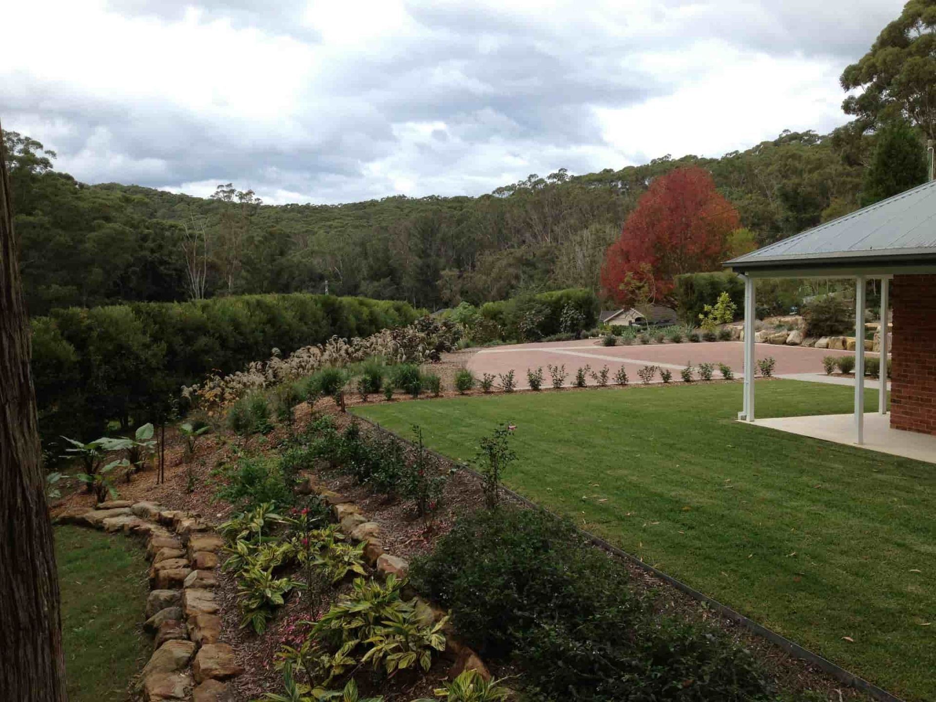 Green Lawn, Garden Beds, and Forested Hills — Divine Landscape Creations in Gosford, NSW