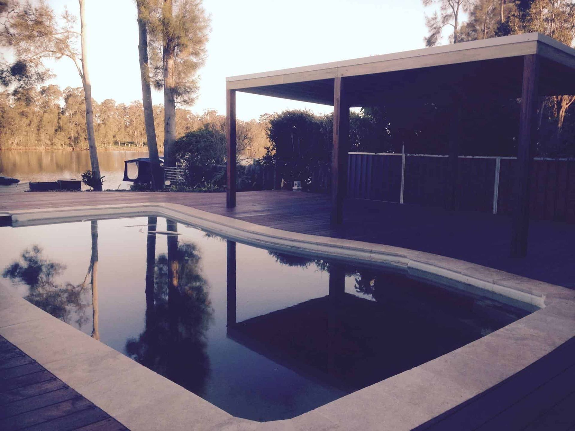 Poolside Scene With Pool Reflecting Sky and Trees — Divine Landscape Creations in Terrigal, NSW