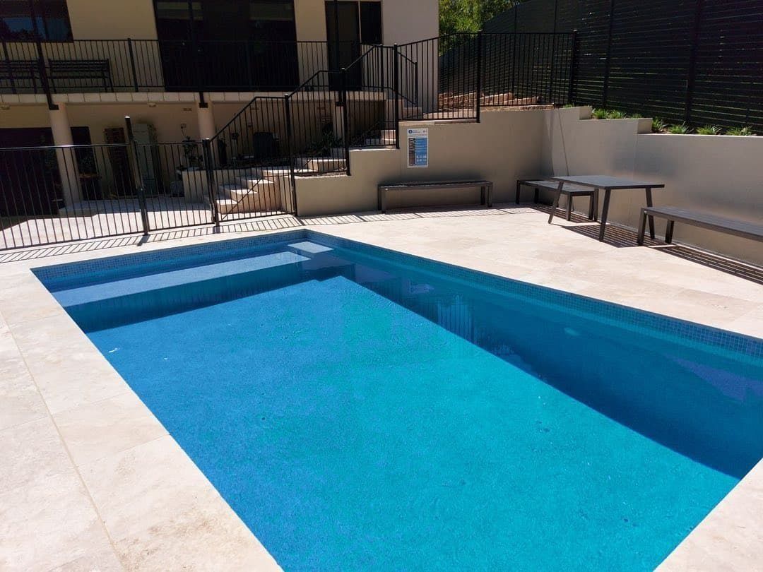 Swimming Pool With Blue Water and Light Stone Surround — Divine Landscape Creations in Gosford, NSW