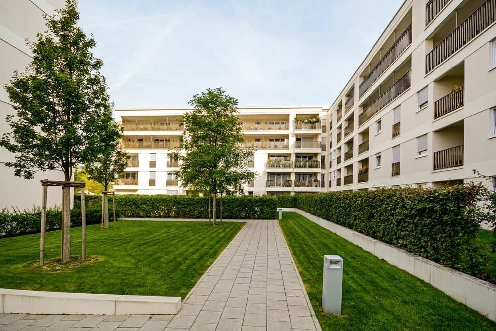Courtyard of Modern Apartment Buildings With Green Lawn — Divine Landscape Creations in Berkeley Vale, NSW