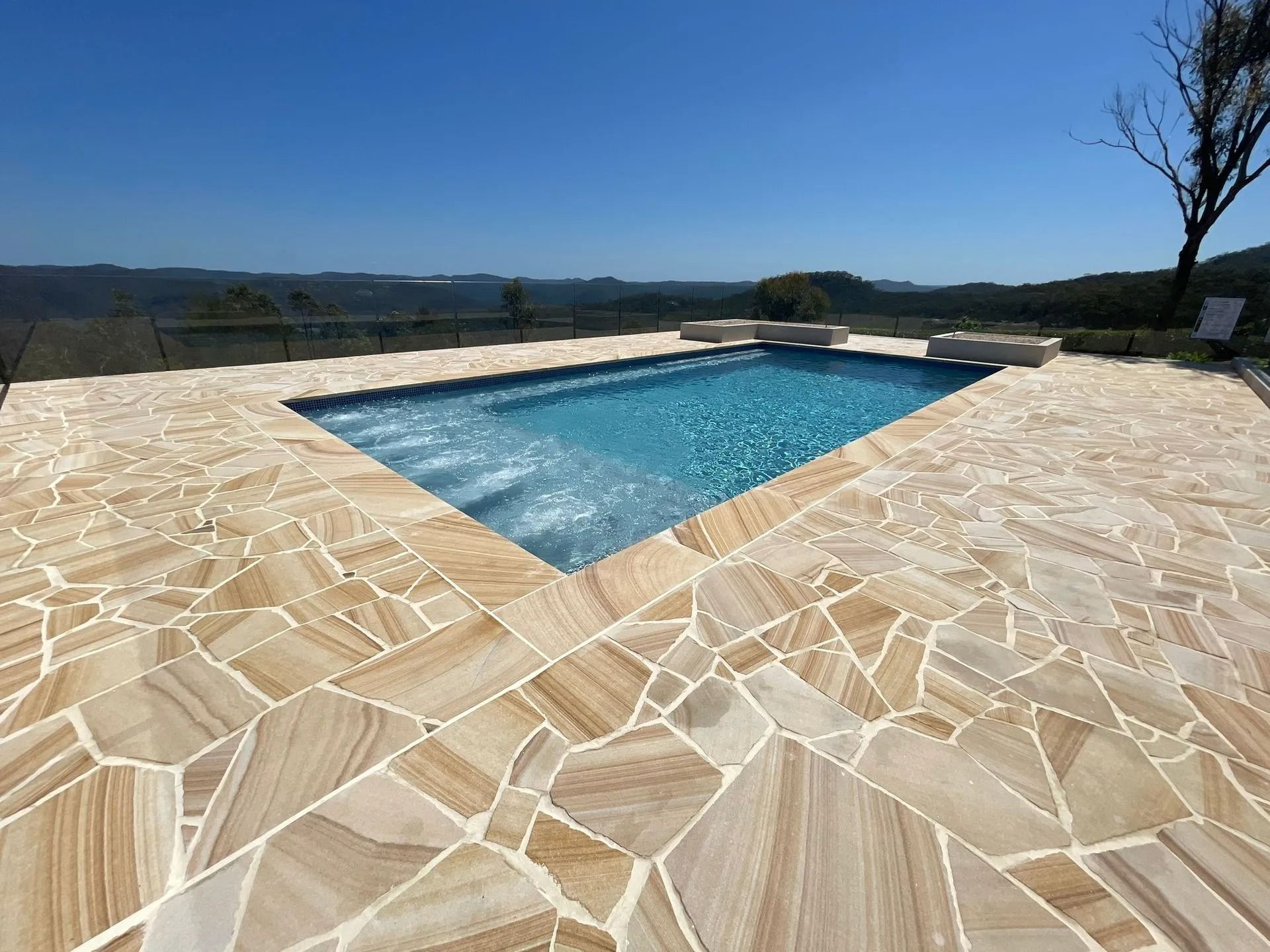 Swimming Pool With Light-colored Stone Surround — Divine Landscape Creations in Erina, NSW