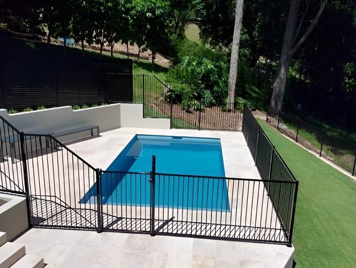 Rectangular Swimming Pool Surrounded by Black Fences — Divine Landscape Creations in Avoca Beach, NSW