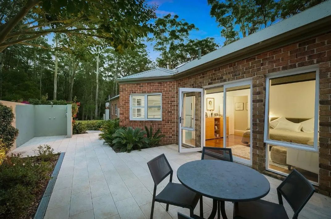 Patio With Brick Building, Table, Chairs, and Door — Divine Landscape Creations in Berkeley Vale, NSW