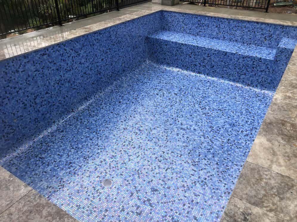 Empty Rectangular Swimming Pool With Blue Mosaic Tile Interior — Divine Landscape Creations in Berkeley Vale, NSW