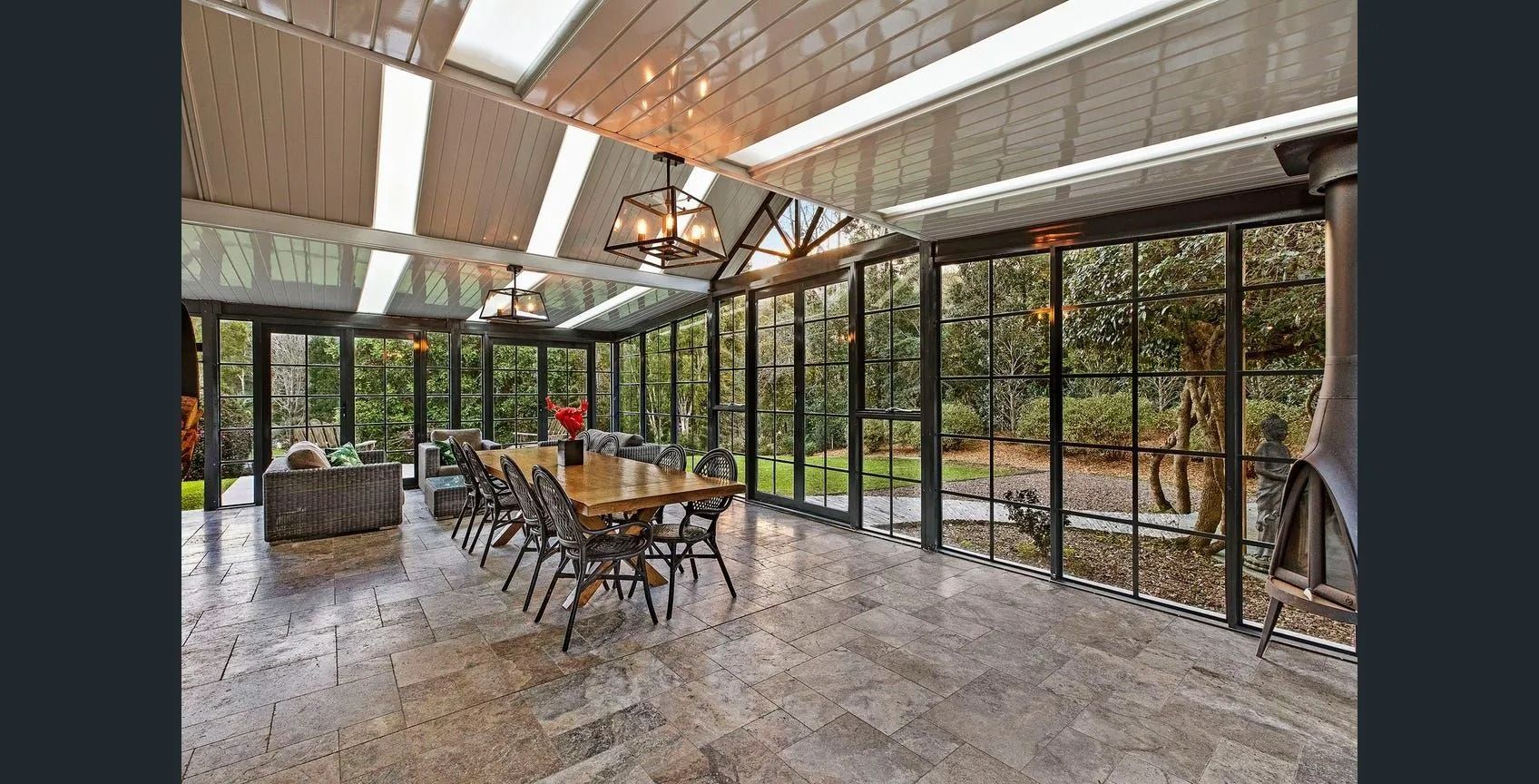 Sunroom With Long Wooden Table and Chairs — Divine Landscape Creations in Berkeley Vale, NSW