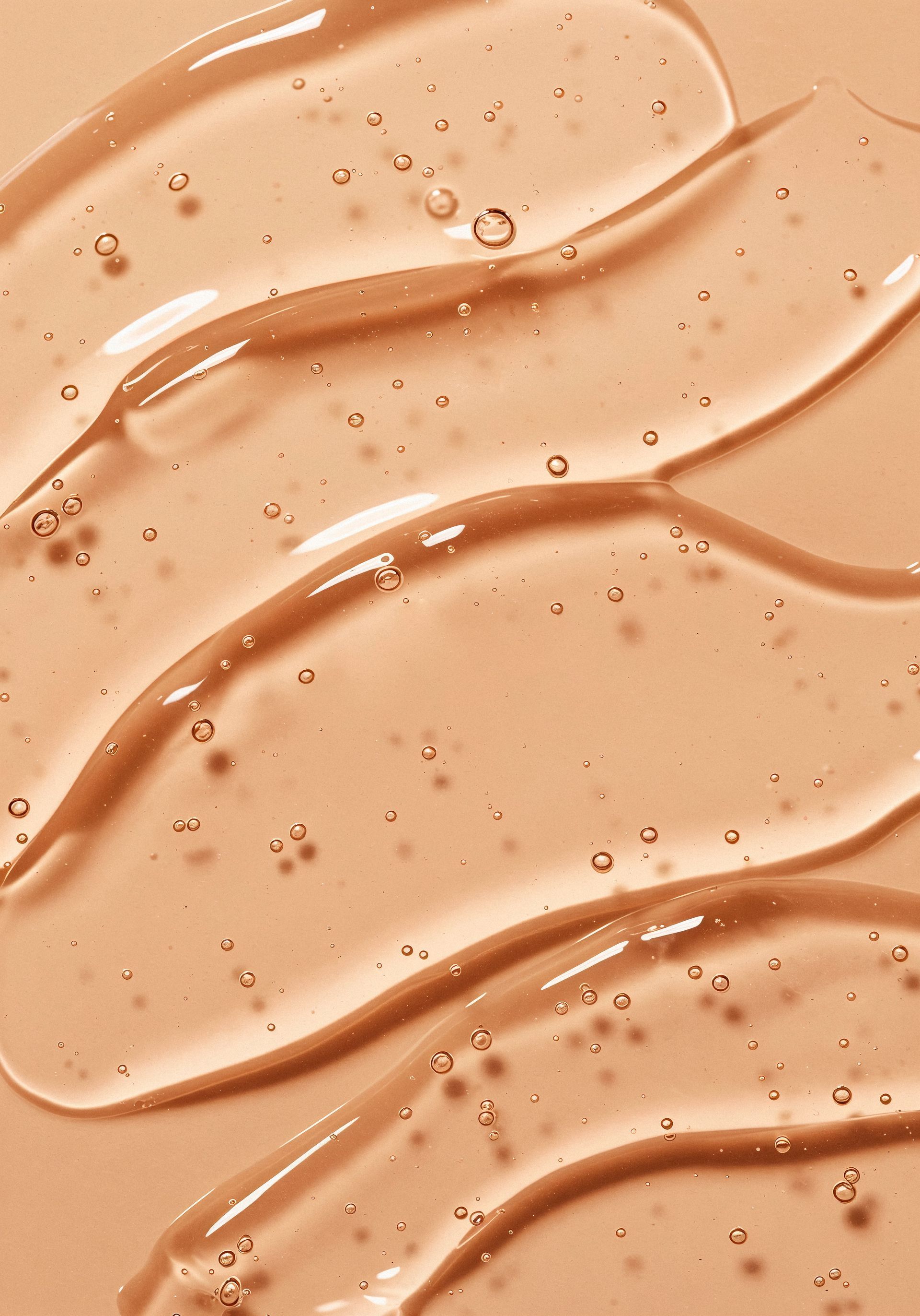 A woman is laying on her back with her eyes closed and her arms outstretched.